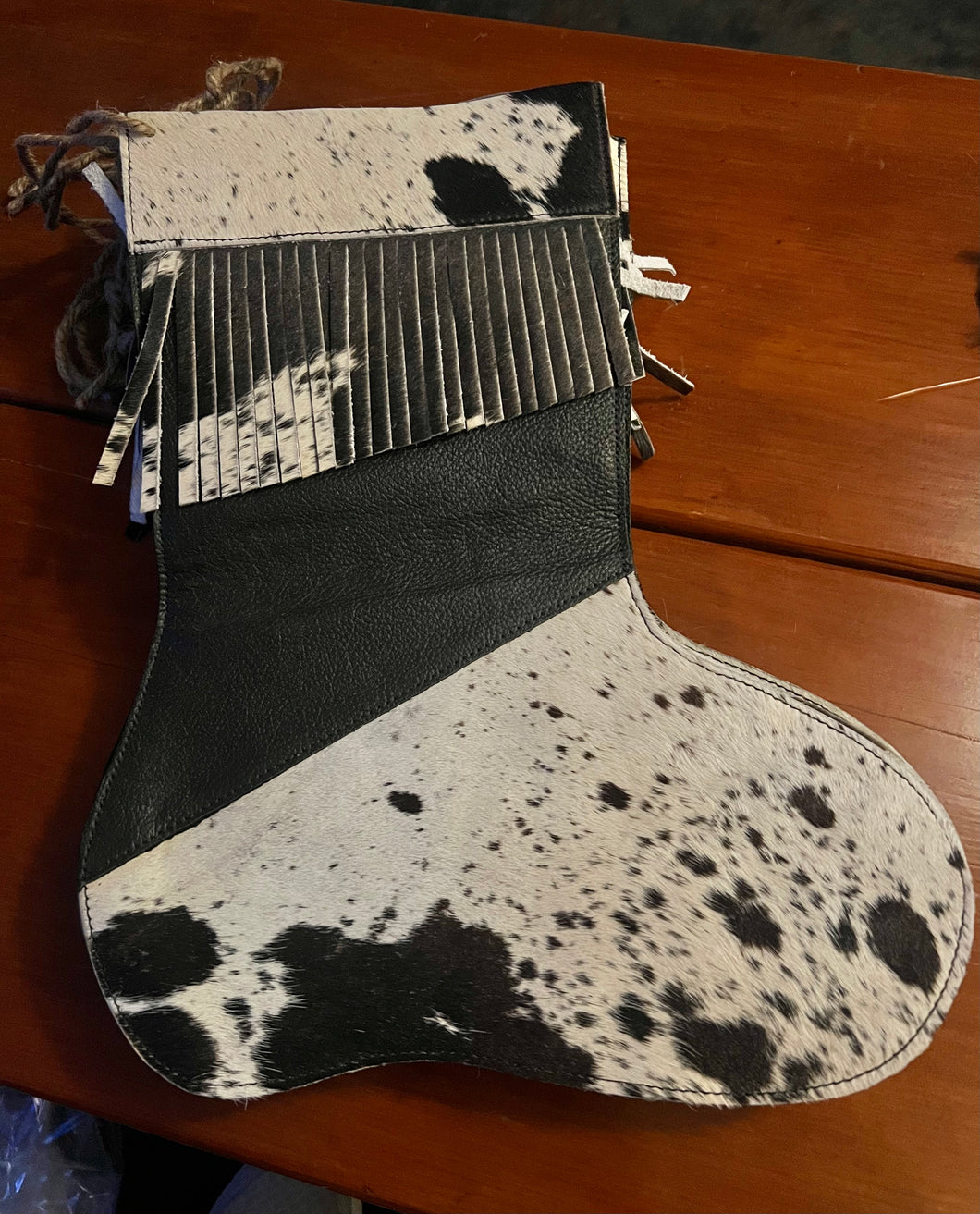 Cowhide stocking, black/white with fringe
