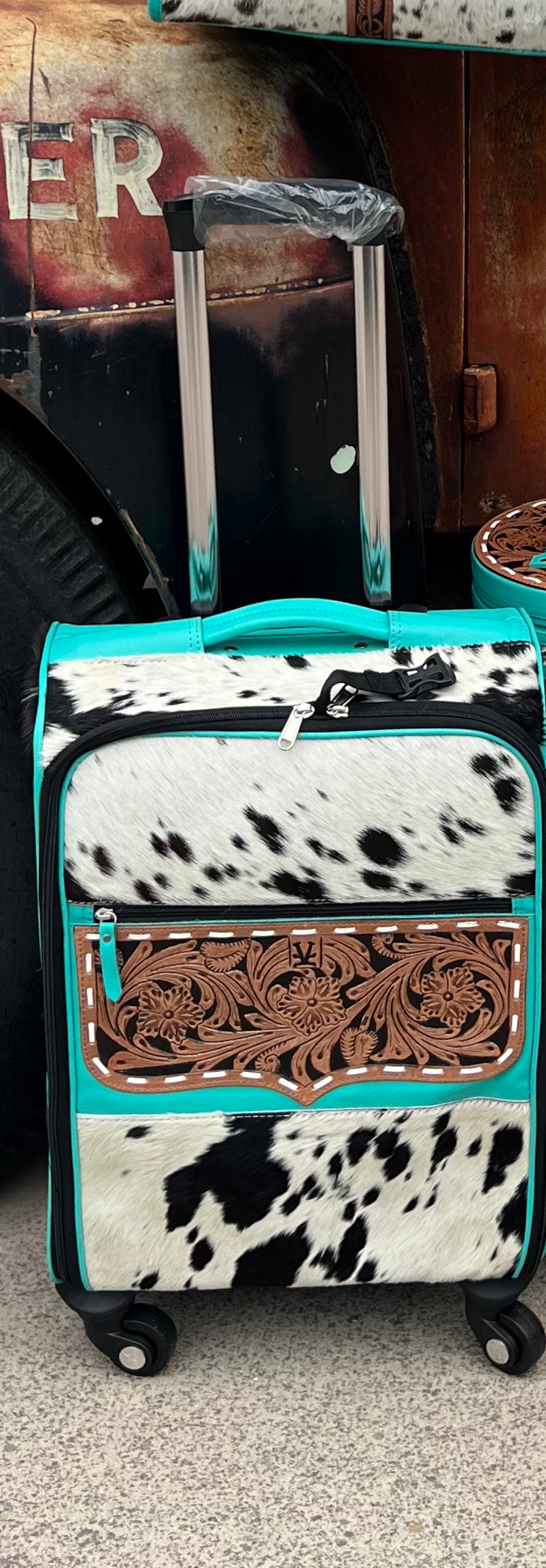 Turquoise black/white cowhide rolling suitcase